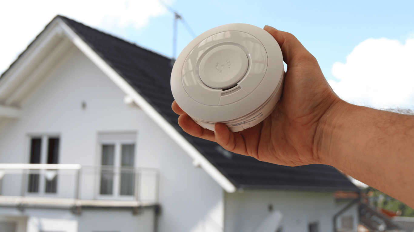 Smoke detector being installed in a residential home for fire safety - Quick Response Fire Protection